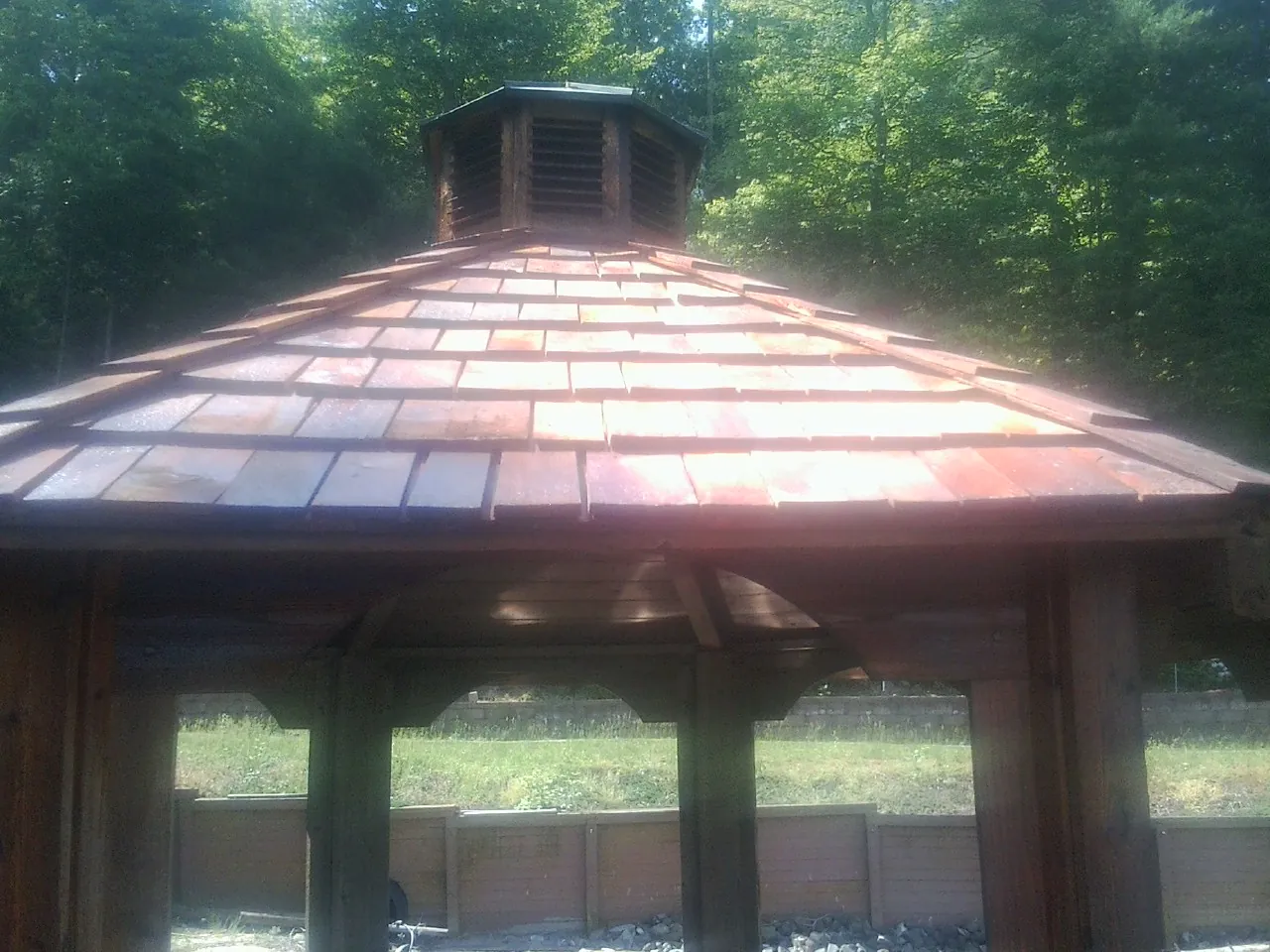 New cedar shake roof and cupola on a lakeside gazebo in Slinger
